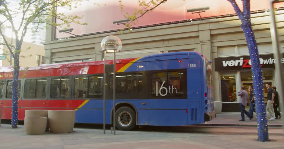 A bus drives on a city street