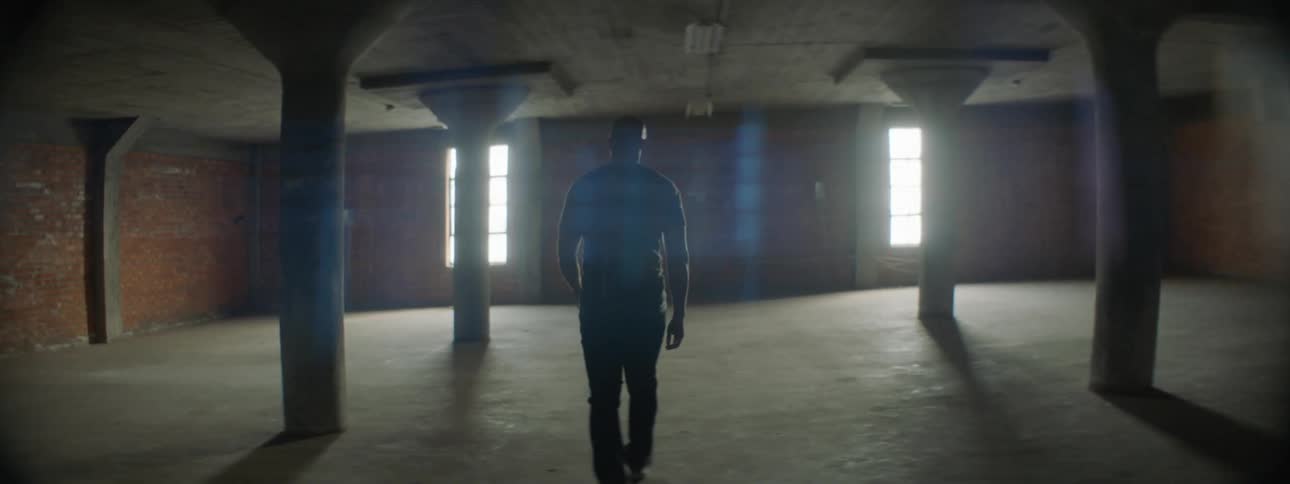 A man walks in an empty room