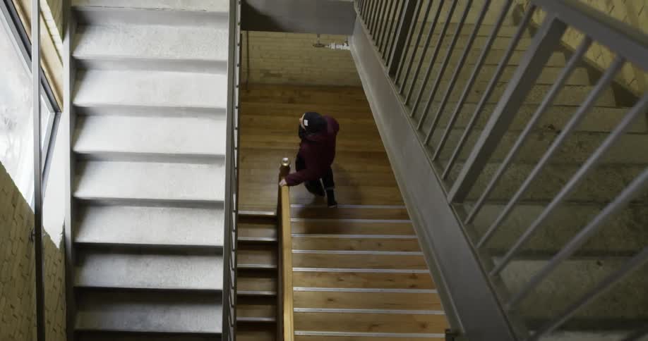 A man is walking down a flight of stairs