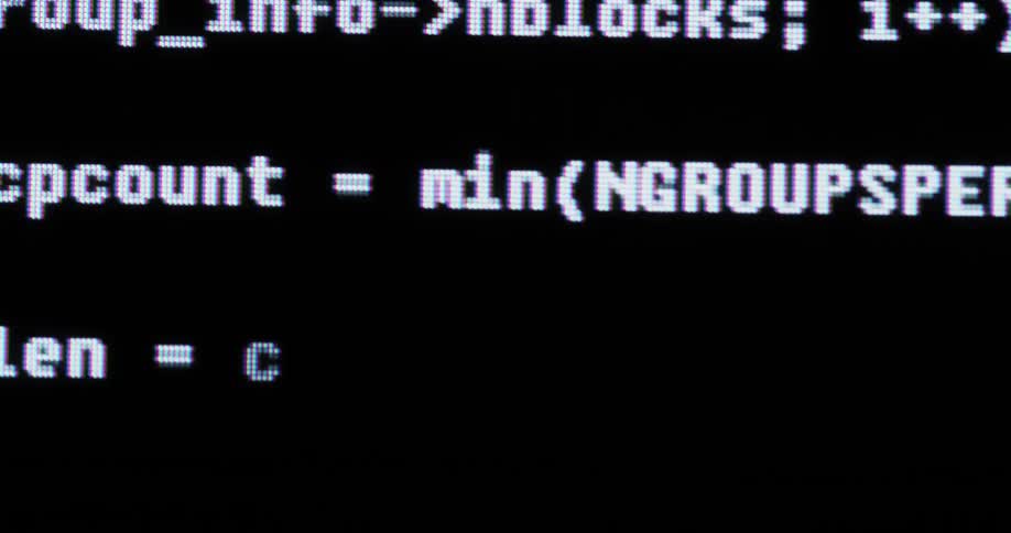 White lines of code flash and scroll on a black screen