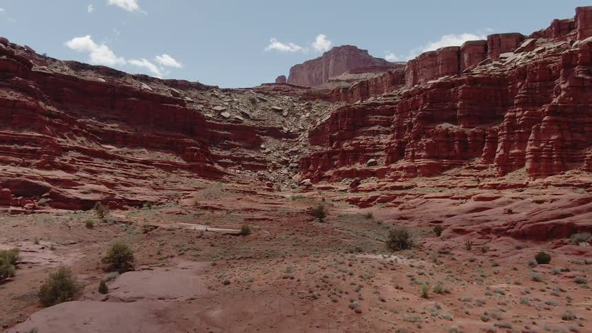 A tumble of rocks is covering a cliffside in a canyon on a sunny day