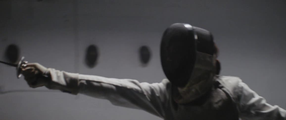 Person practices fencing while wearing a mask