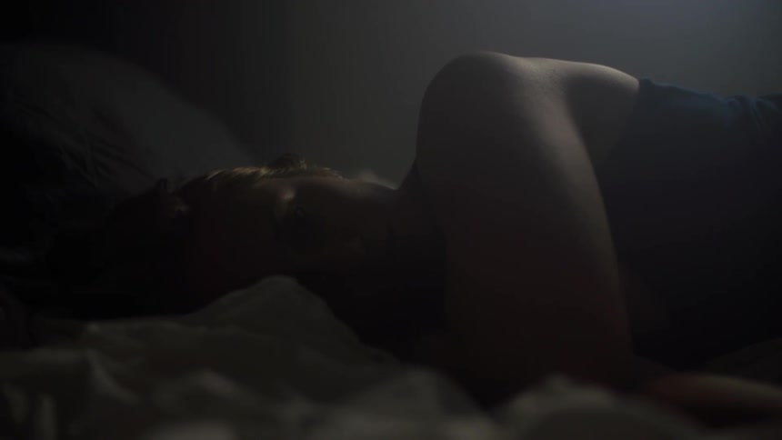 A woman lying in bed on her side