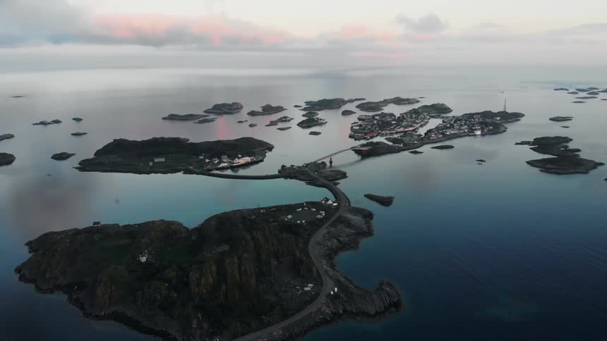 Several small islands and bridges in a large body of water at sunset