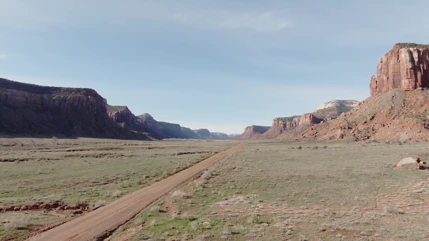 A road runs through a desert landscape