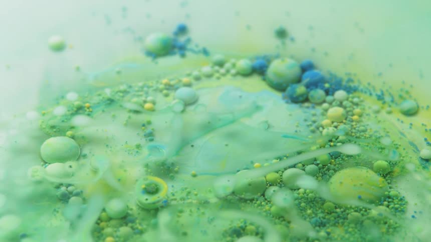 Blue and green bubbles sit in a green liquid