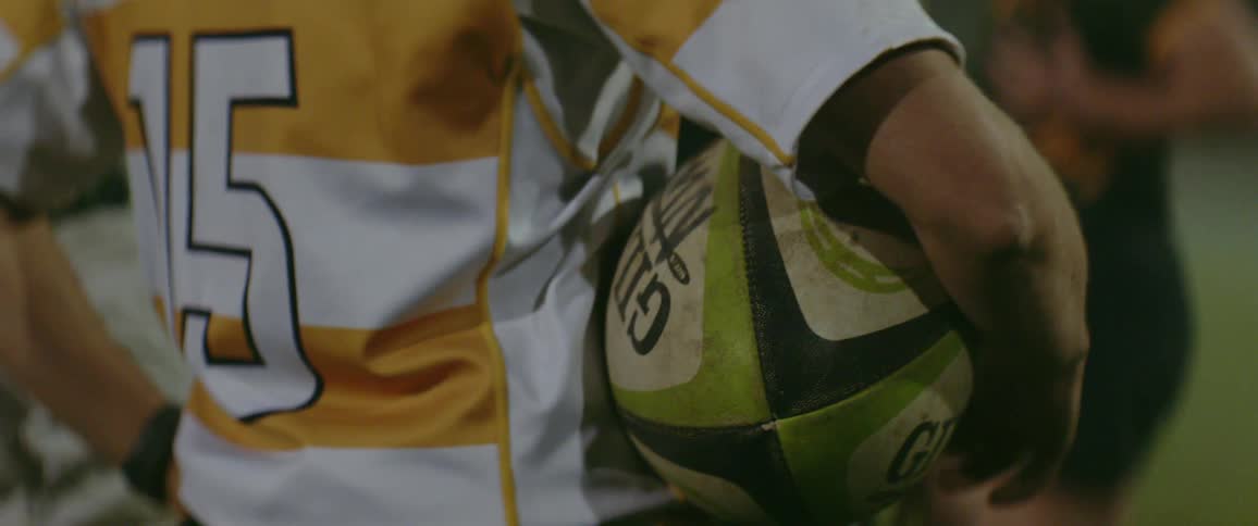 Person wearing a uniform holds a ball
