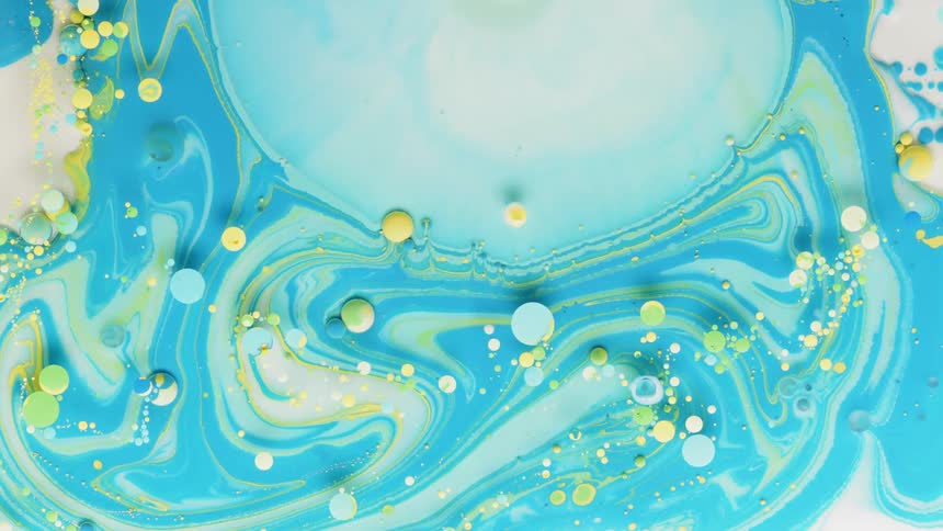 Yellow and blue bubbles sit in a blue liquid