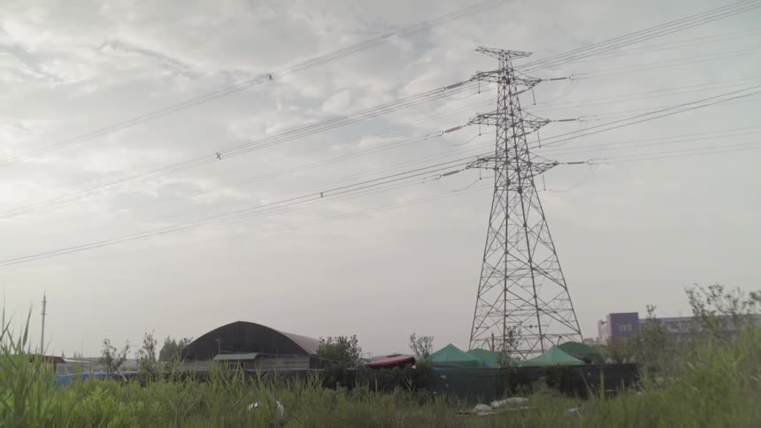 The power line runs over the farm ahead