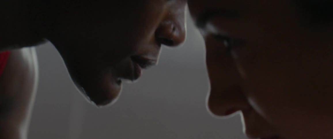 Two wrestlers stand face to face