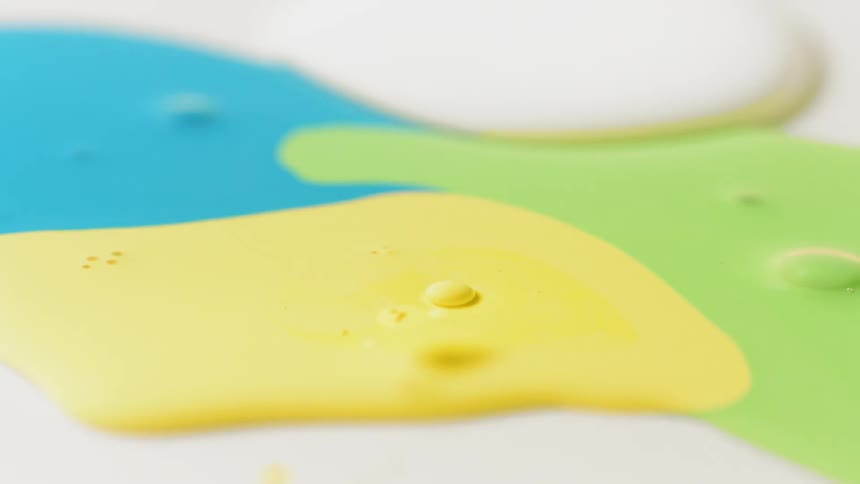 Blue yellow and green paint flow together