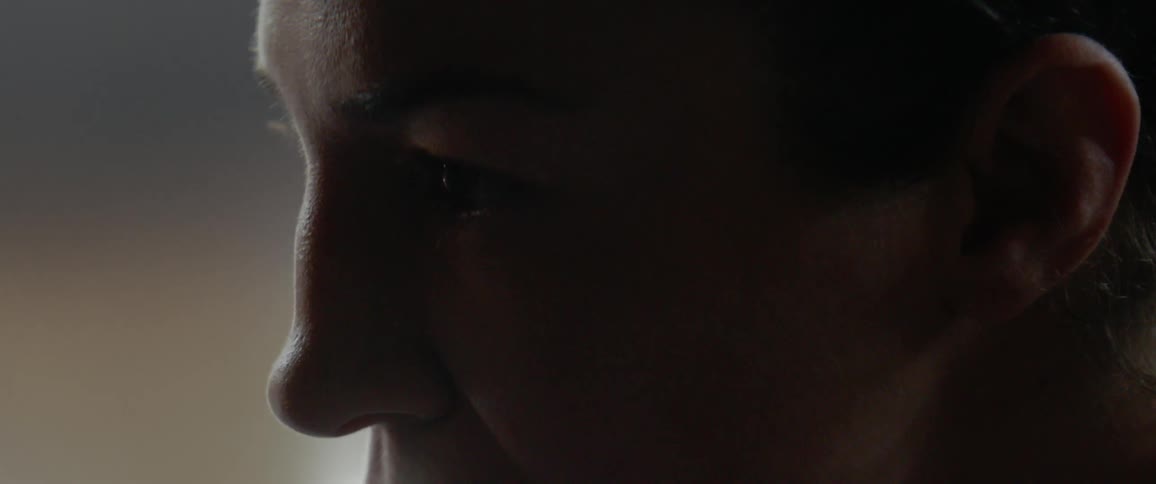 The person is looking forward in the dark