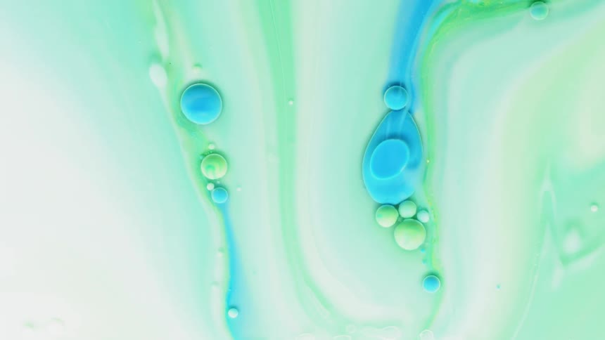 Blue, green and white liquid swirling with bubbles in it