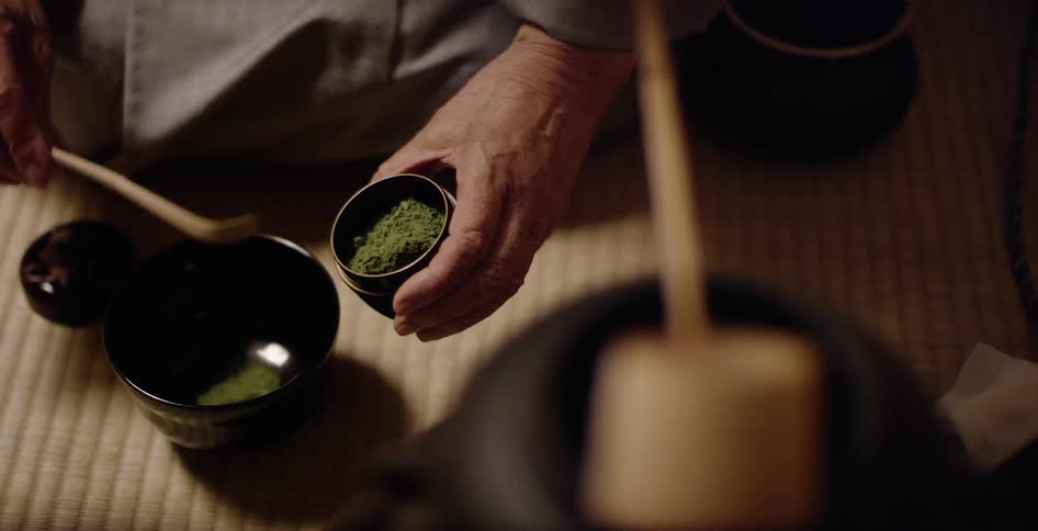 Man scoops green powder into a bowl