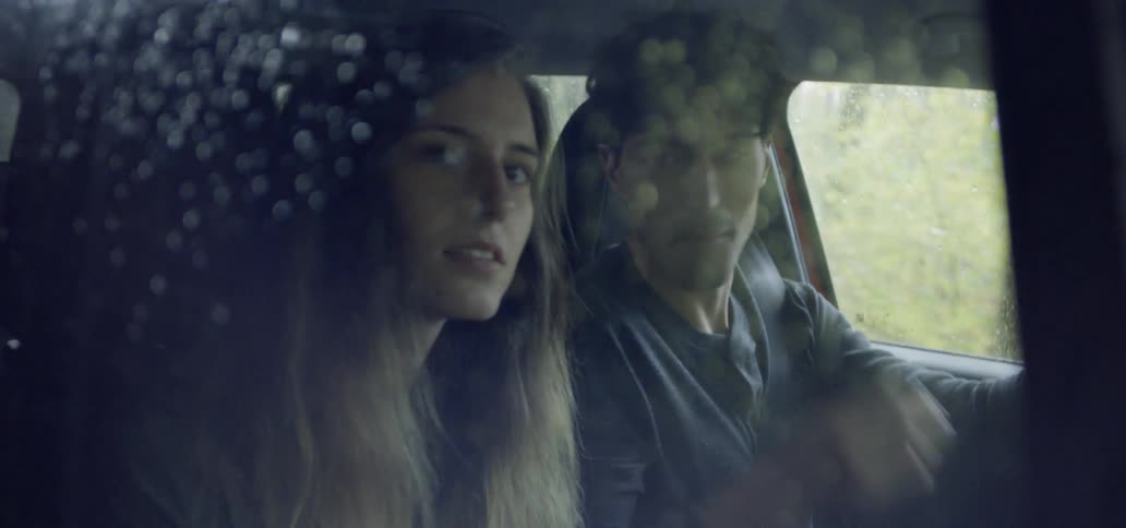Man and woman riding in a vehicle in the country