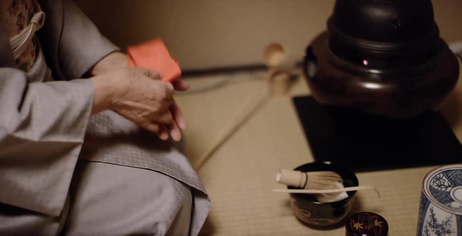 Woman folds a napkin then picks up a stick
