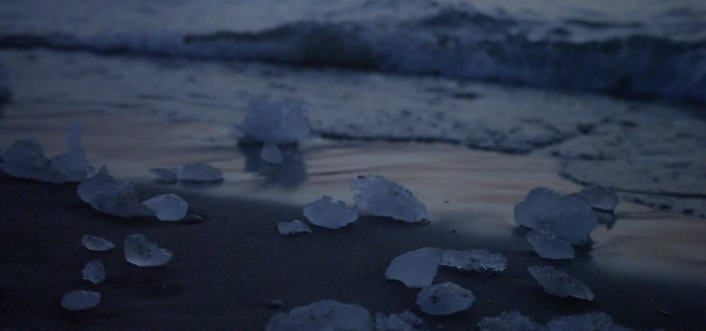 Waves roll into the sandy beach