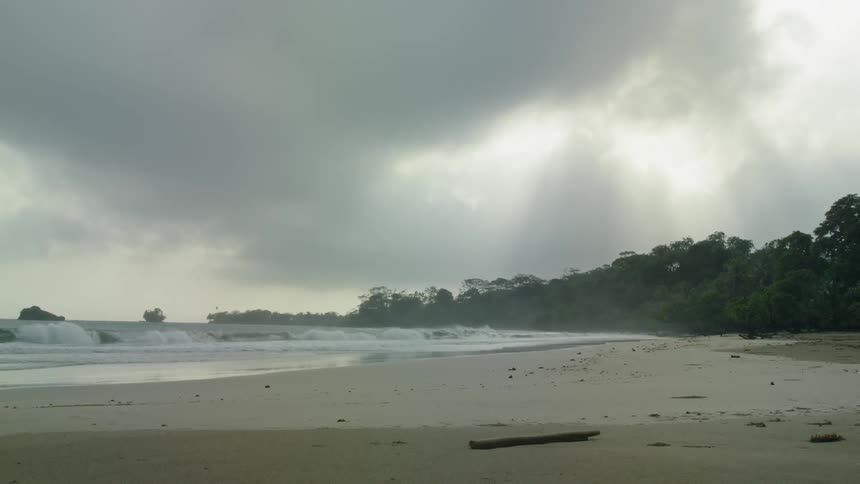 Ocean waves wash ashore a sandy beach