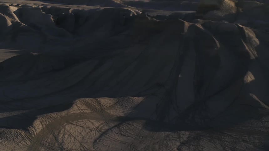 The sun is setting behind the canyons ahead