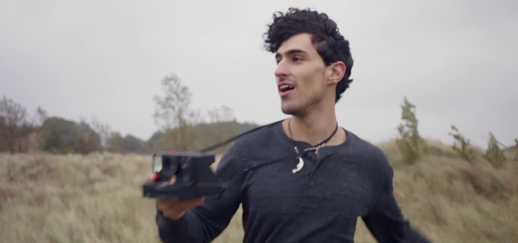 A man is taking photos on a windy day