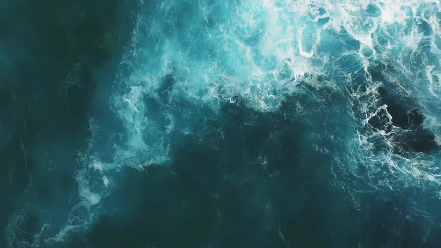 Blue waves flow towards the rock