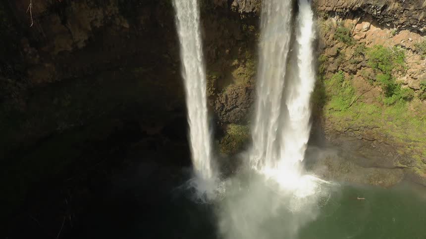 Waterfalls flow over a cliff
