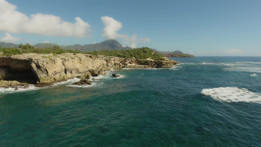 Waves flow towards the rocky shore