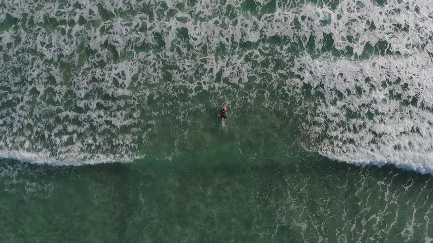 A person floats on the surface as waves flow