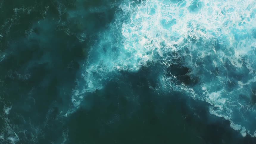 The blue waters are rough below