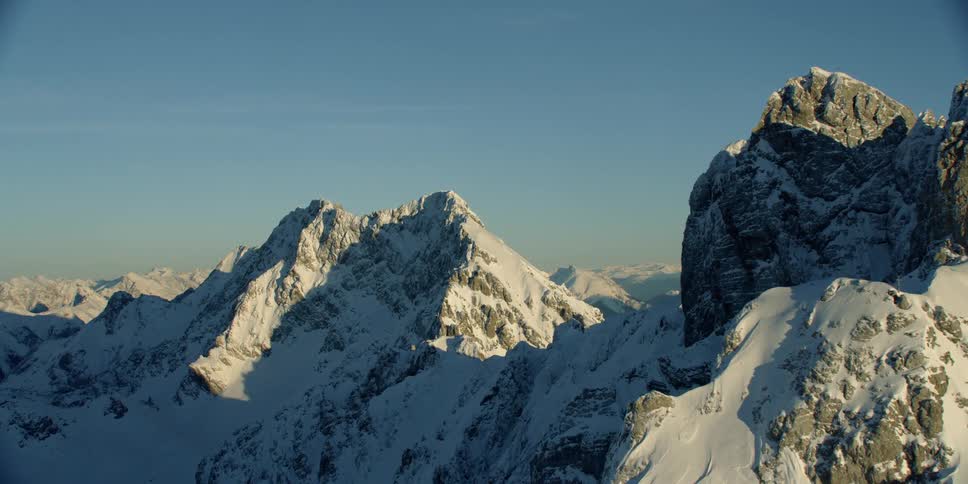 The tall mountains are covered with thick snow