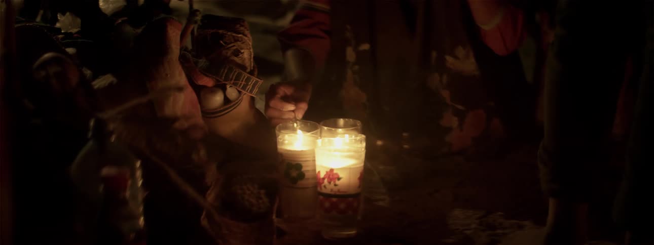 Candles are lit in the dark