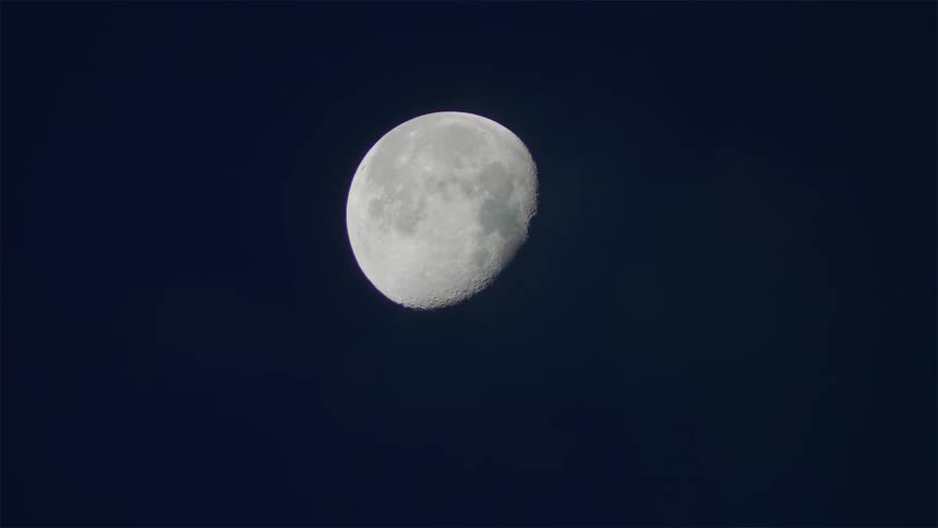 An almost full moon in a clear sky
