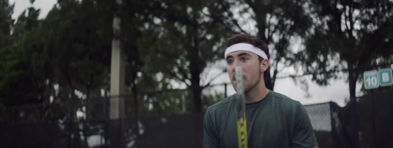 A man runs up to hit the tennis ball