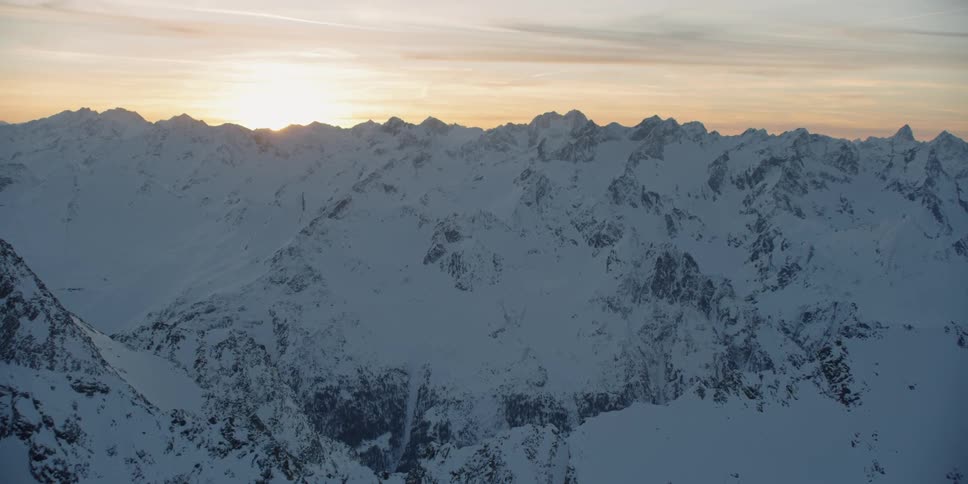 The sun is setting behind the mountains