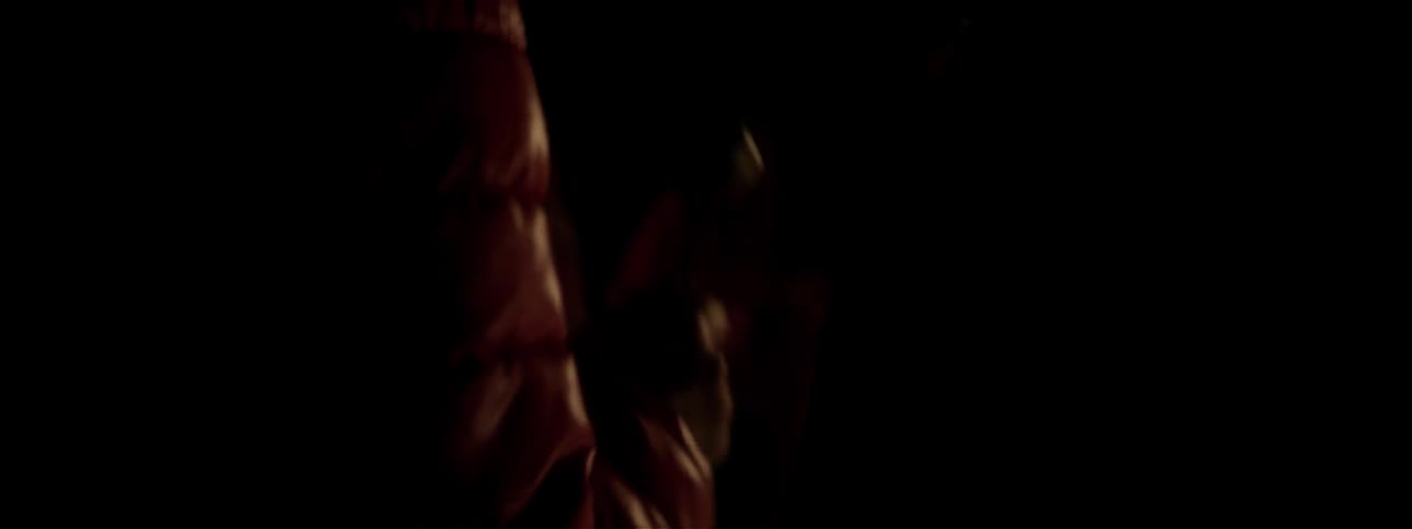 People are shaking instruments in a dark area