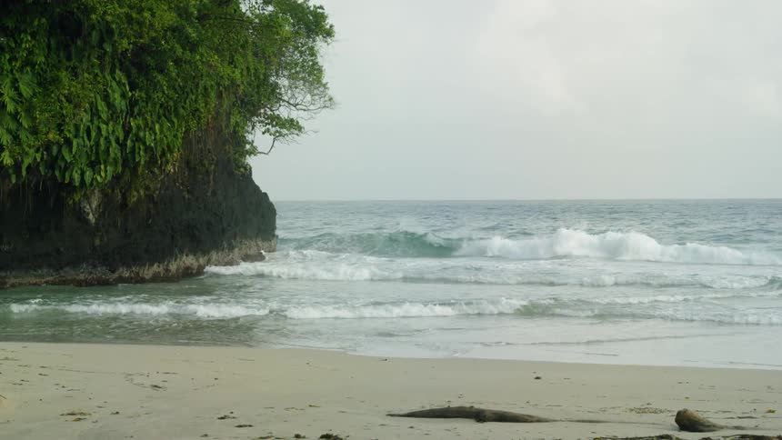 The waves flow onto the beach shore
