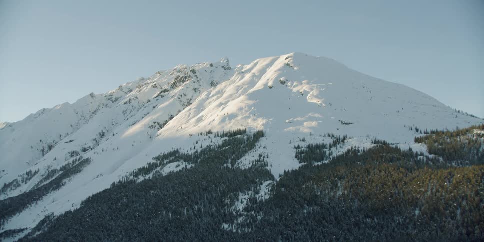 Snow covers the tall mountain