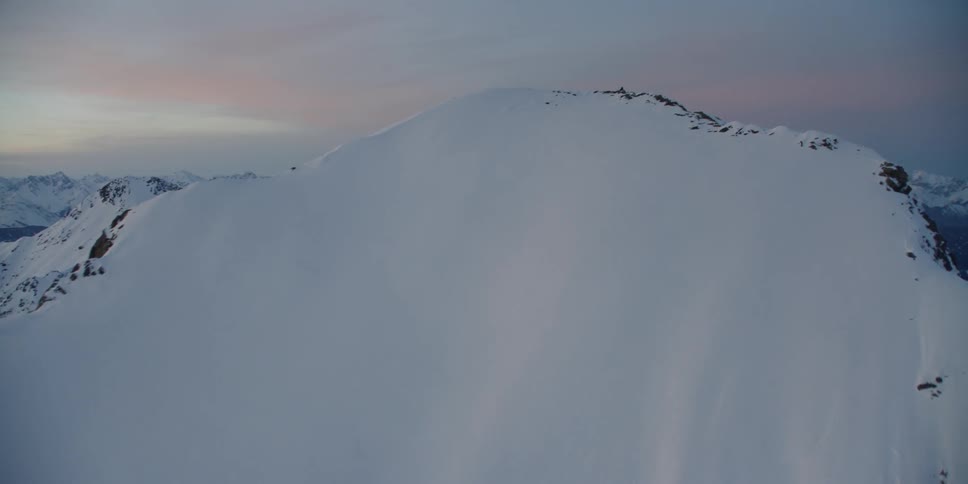 The tall mountain range has thick clouds above