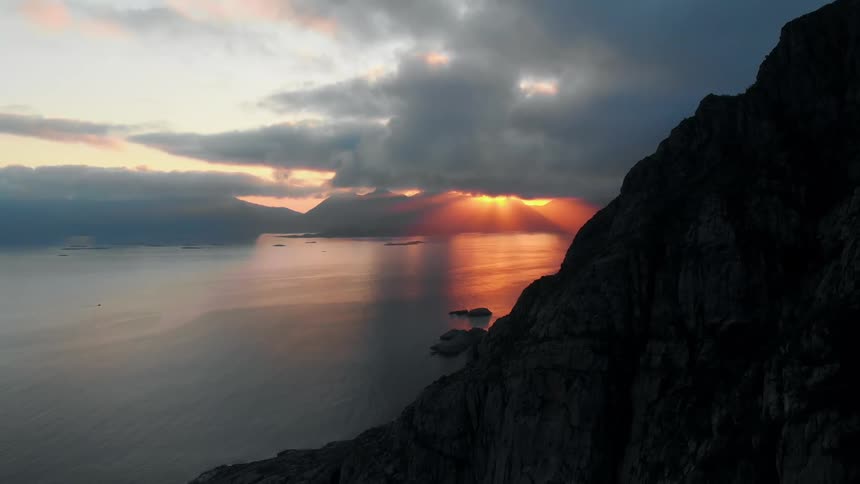 Sun sets behind the clouds over a lake