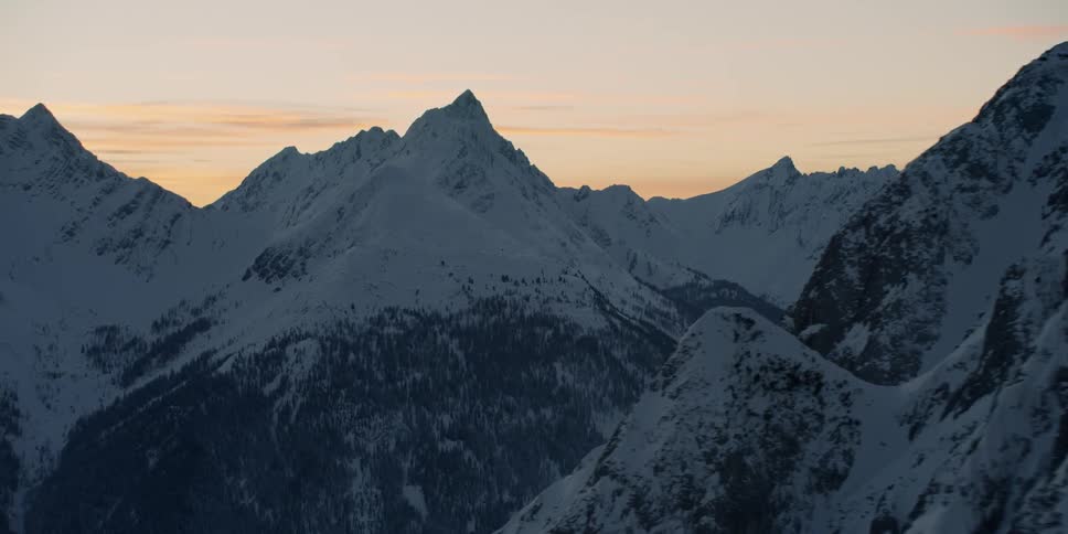 Snow covered mountains under a blue sky
