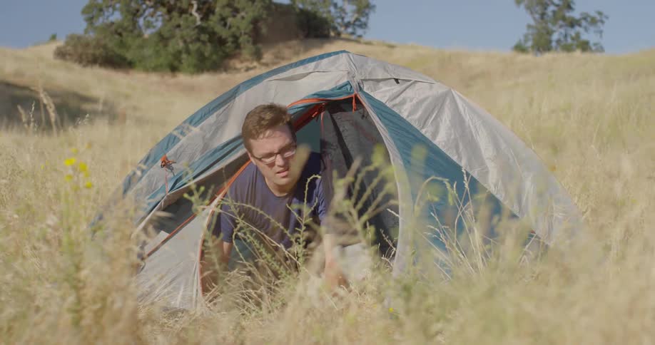 A man exits a tent