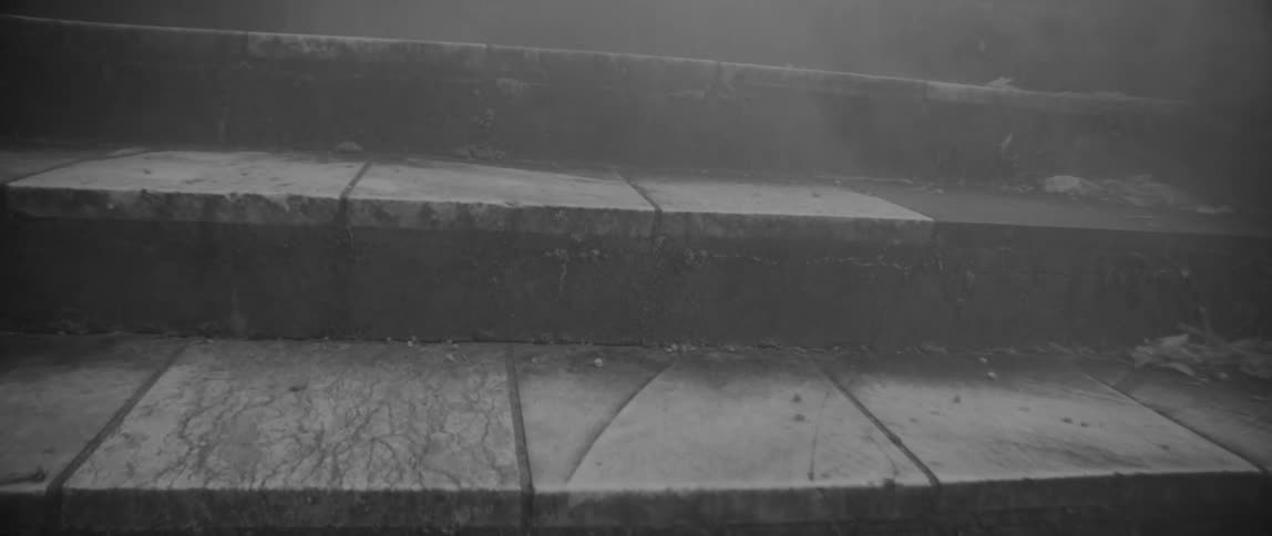 Smoke billows over stone steps