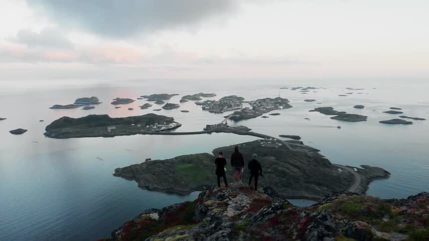 Three men stand on the cliff