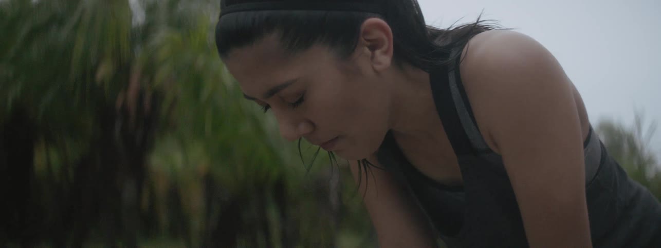The woman leans forward to catch her breath