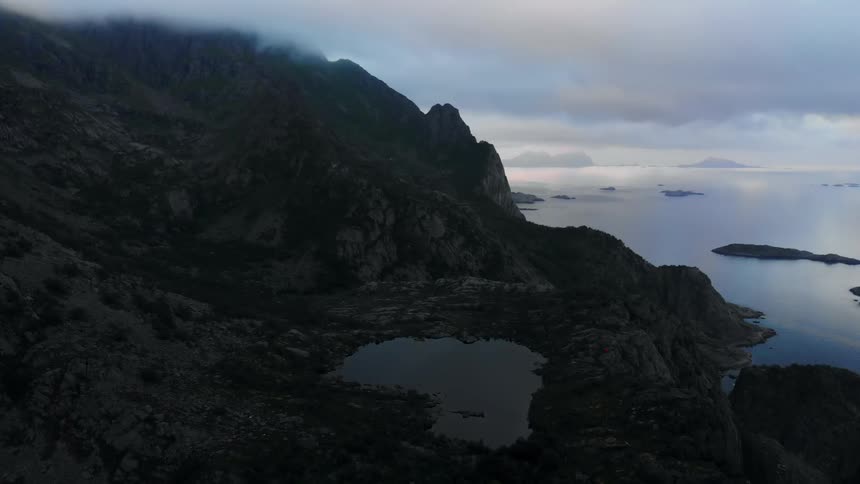 The heavy clouds cover the tall mountain