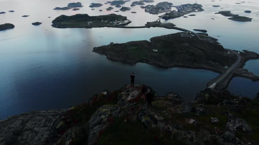 People are walking towards the edge of a cliff