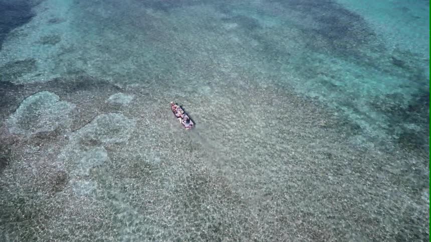 A boat floating in crystal clear waters