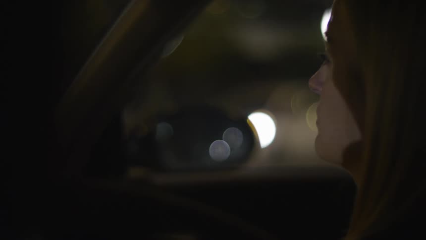 Woman in a vehicle at night