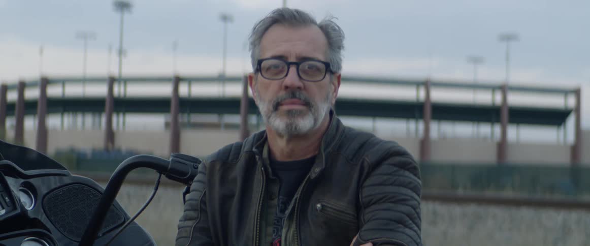 Man sits on a motorcycle