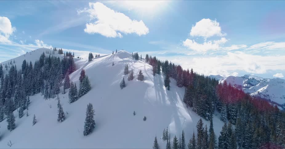 Sunlight is streaming down over a mountain in winter